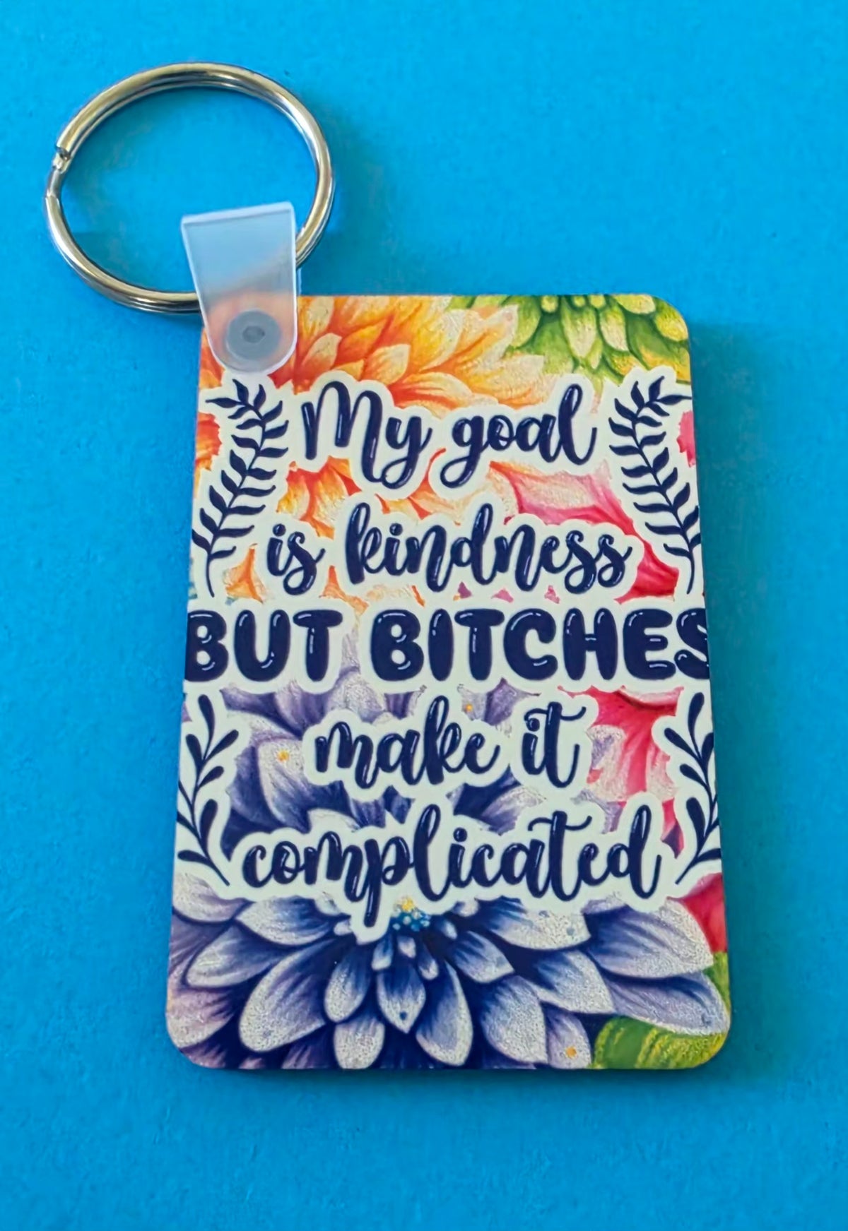 Keychain with floral design and humorous text on a blue background.
Homemade - BH Creations By Mel
