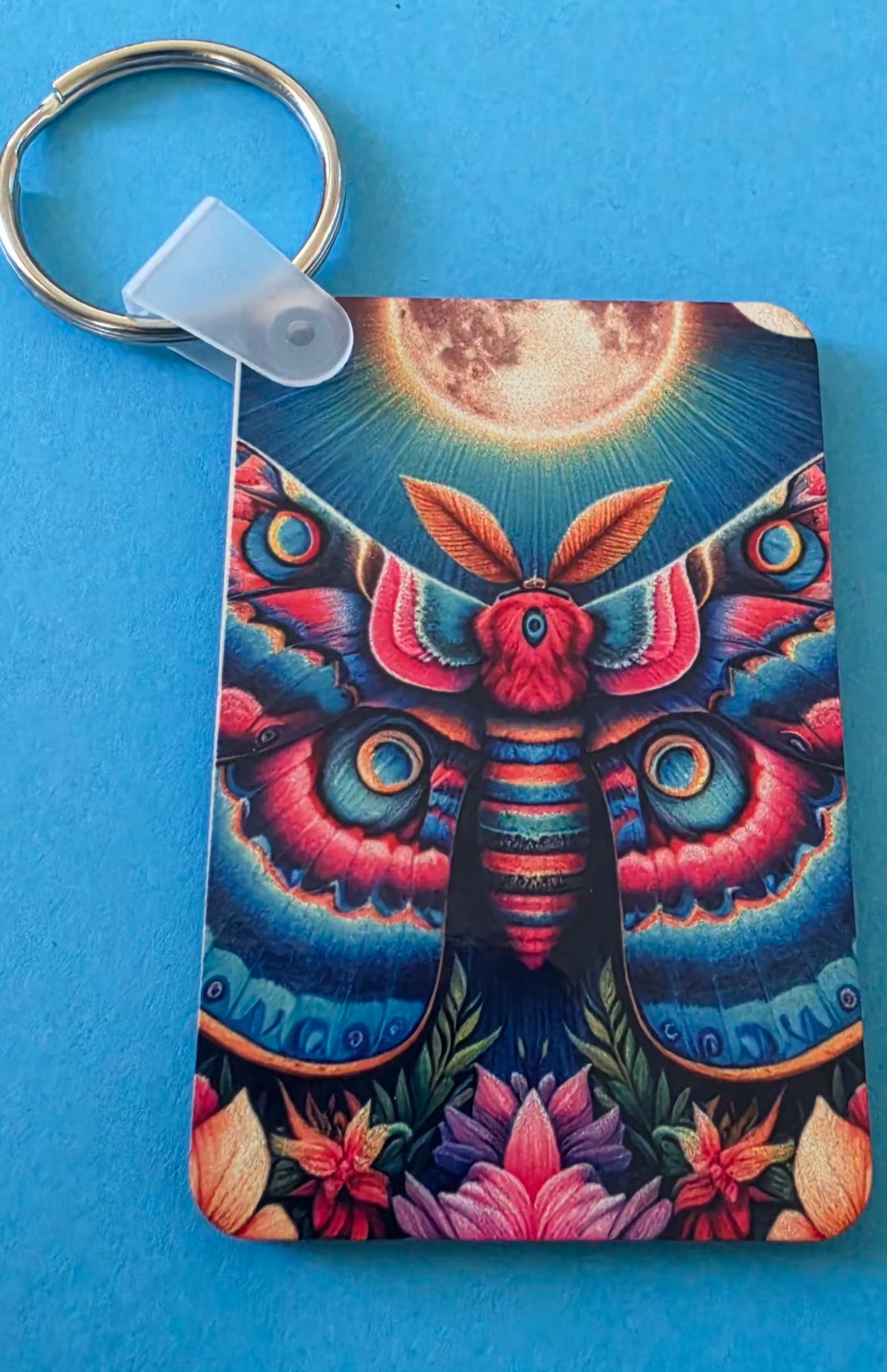 Colorful moth design keychain on a blue background.
Homemade - BH Creations By Mel