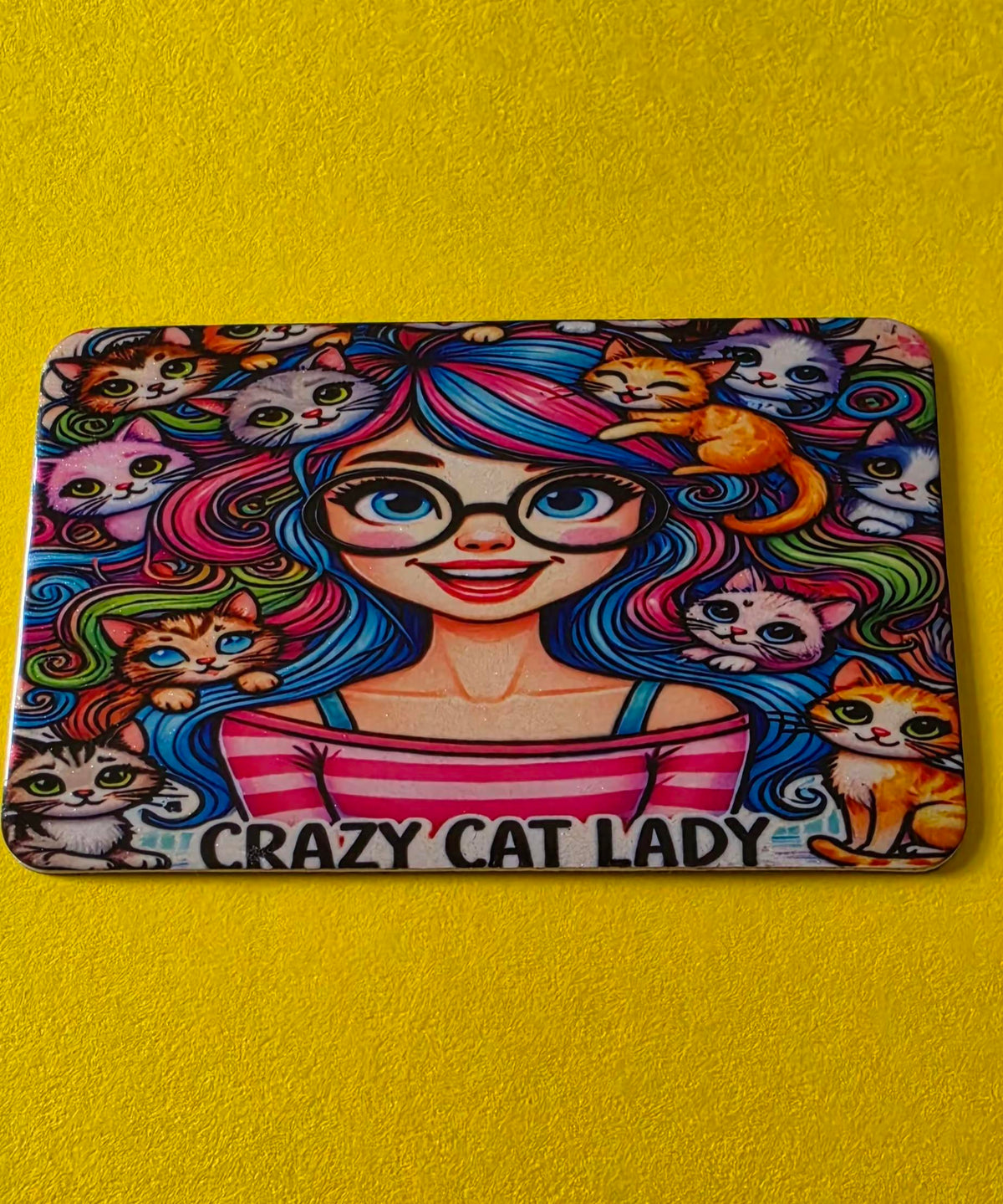 Magnet with a design of a woman with colorful hair and cats, labeled 'Crazy Cat Lady', on a yellow background.
Homemade - BH Creations By Mel