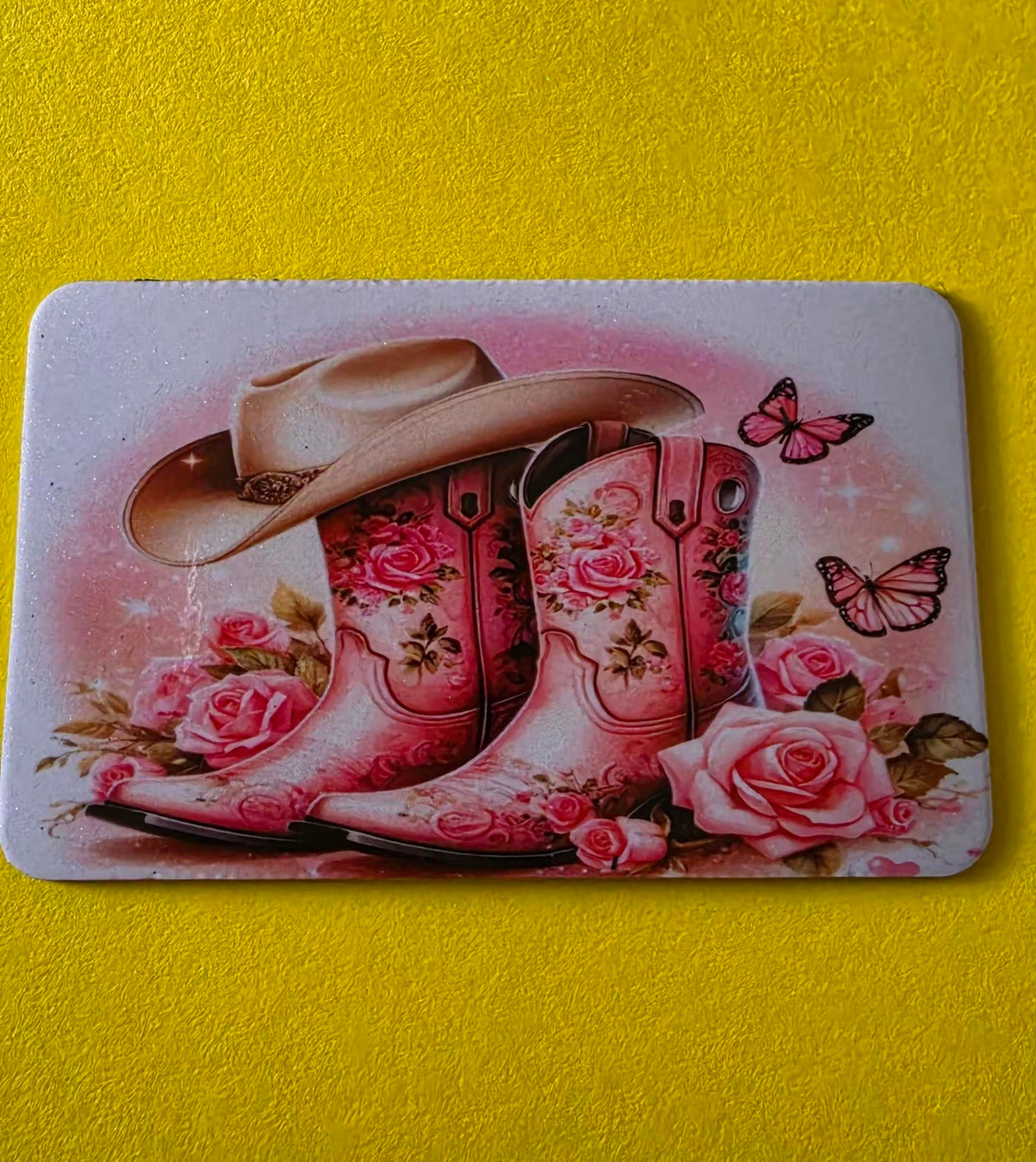 Magnet with pink cowboy boots, hat, and roses on a yellow background.
Handmade - BH Creations By Mel
