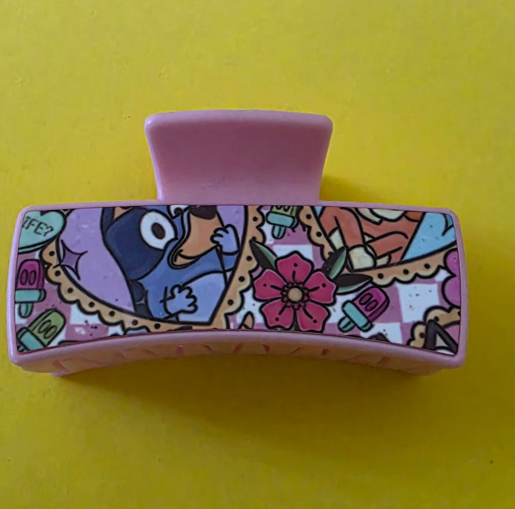 Small pink claw clip with Bluey character on a yellow background.
Homemade - BH Creations By Mel